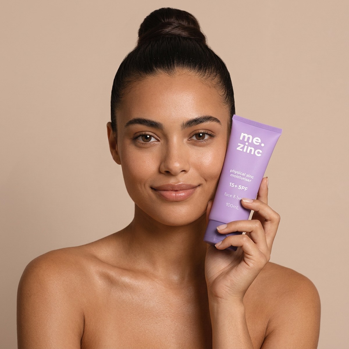 Model holding the me.zinc physical zinc moisturiser
